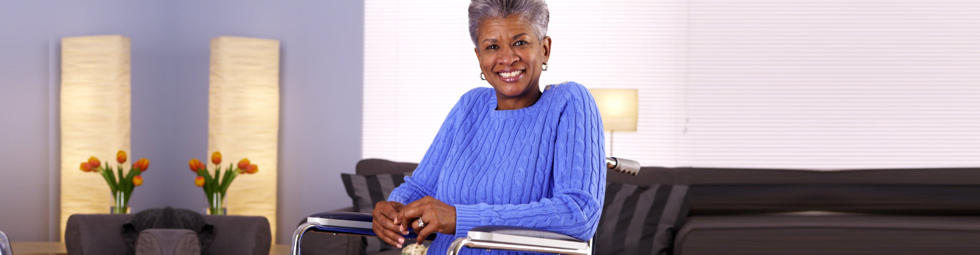 senior woman sitting in the wheelchair smiling